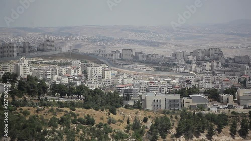 Cars drive in jerusalem next to separation wall, Mount Scopus, Israel Palestine