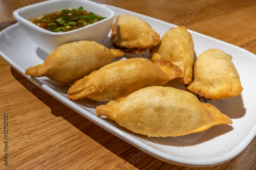 Chinese dumplings on plate with dipping sauce