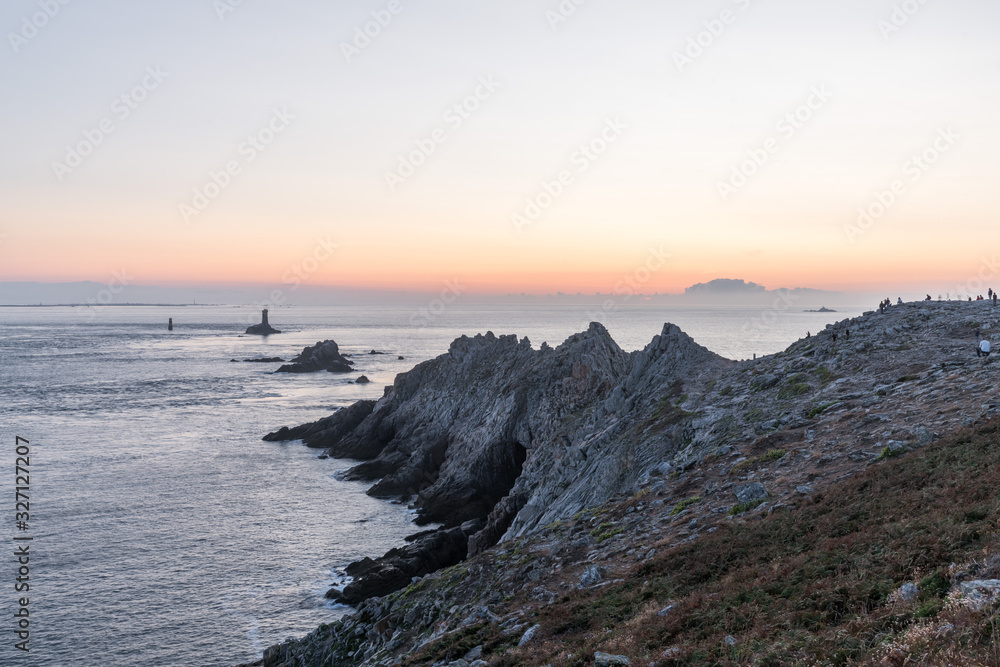 Sunset landscapes at the Raz Point (Pointe du Raz) with cliffs into the sea, Brittany, France