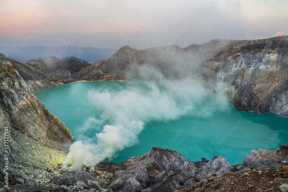 Blue sulfur acidic lake of Mount Ijen volcano with poison smoke on East-Java, Indonesia