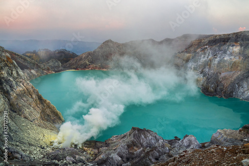 Blue sulfur acidic lake of Mount Ijen volcano with poison smoke on East-Java, Indonesia