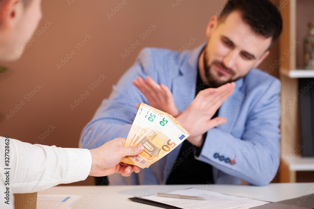 Business man refusing money to take the bribe the concept of corruption and anti bribery Business man refusing money to take the bribe the concept of corruption and anti bribery