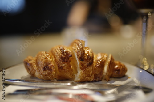 sliced Croissant on white dish in coffee shop