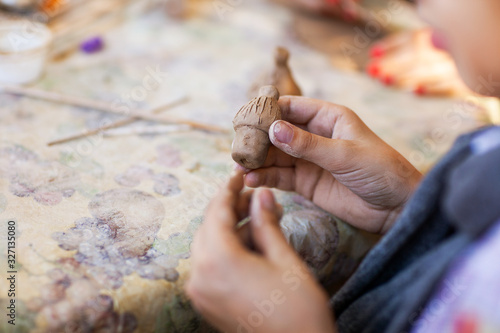 children make clay figures by pottery
