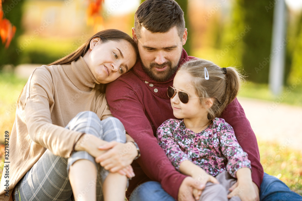 Obraz premium family with daughter walks in autumn park