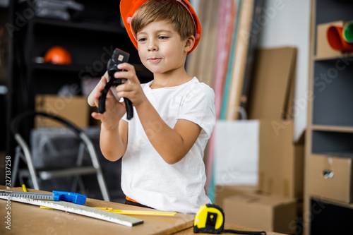 Cheerful little boy with pliers stock photo