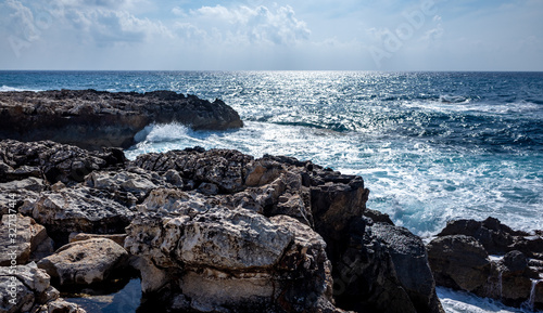 Waves crash on the rocky shore of the Mediterranean Sea on the Akamas Peninsula in the northwest of the island of Cyprus.