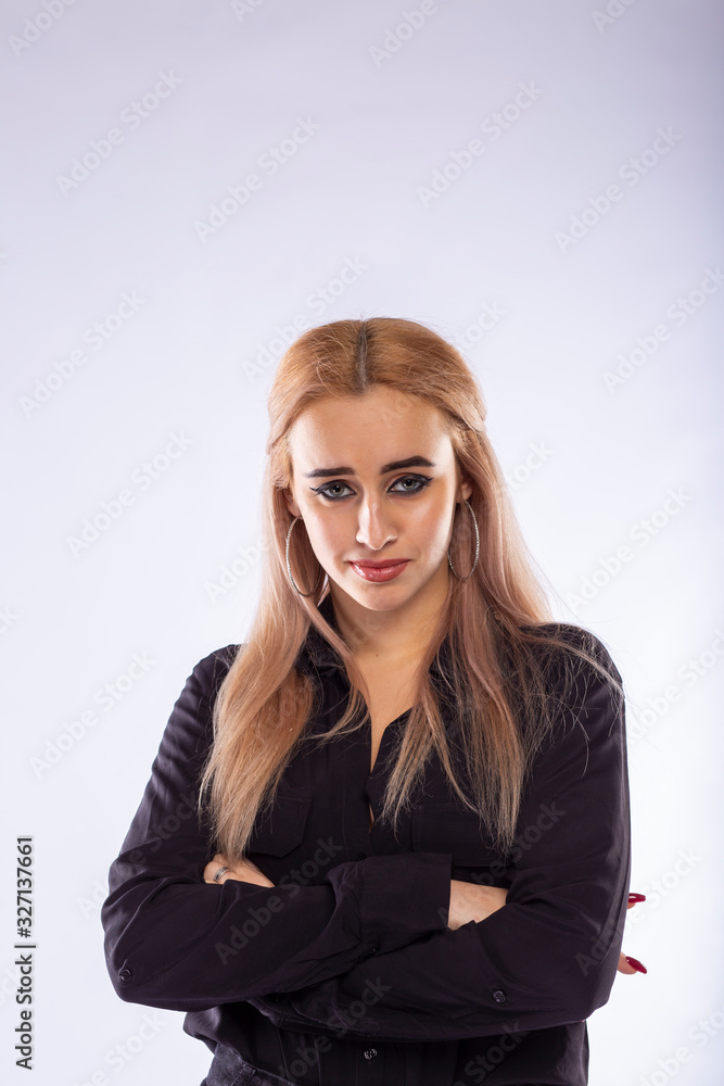 Young pretty blonde woman in black clothes on white background