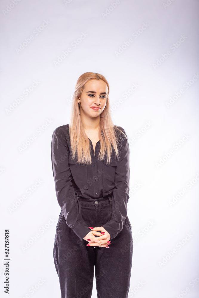 Young pretty blonde woman in black clothes on white background Young pretty blonde woman in black clothes on white background