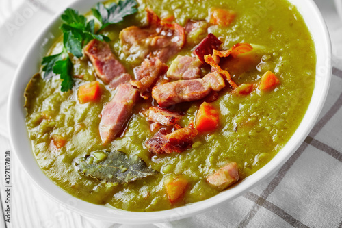 Traditional split pea soup on a white wooden table