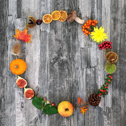 Canvas Print Autumn wreath harvest festival composition with a variety of natural flora & food on rustic wood background