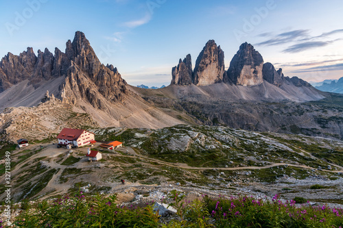 Famous mountains Three Peaks in the Dolomites with the alpine hut Dreizinnenhuette during sunset photo