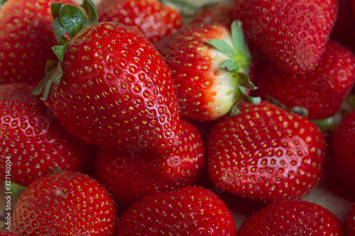 Many red strawberries fruity background