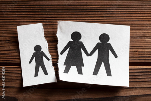Deprivation of parental rights. A piece of paper with parents and a torn piece of paper with a child