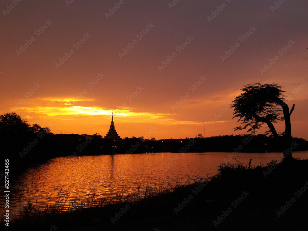 beautiful sunset near the temple by the lake in the evening