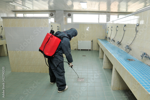 Disinfecting of public toilets to prevent COVID-19 photo