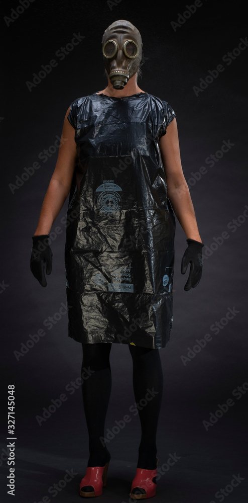 Woman in gas mask and plastic bag in photostudio Woman in gas mask and plastic bag in photostudio