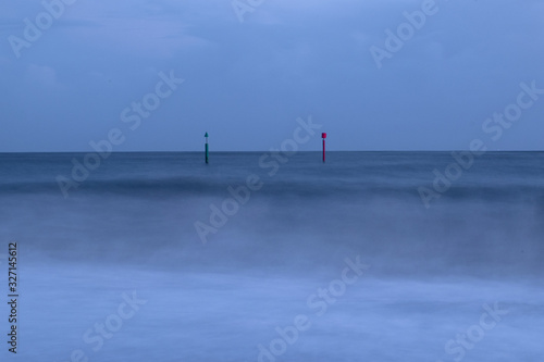 Gren and red posts in the sea