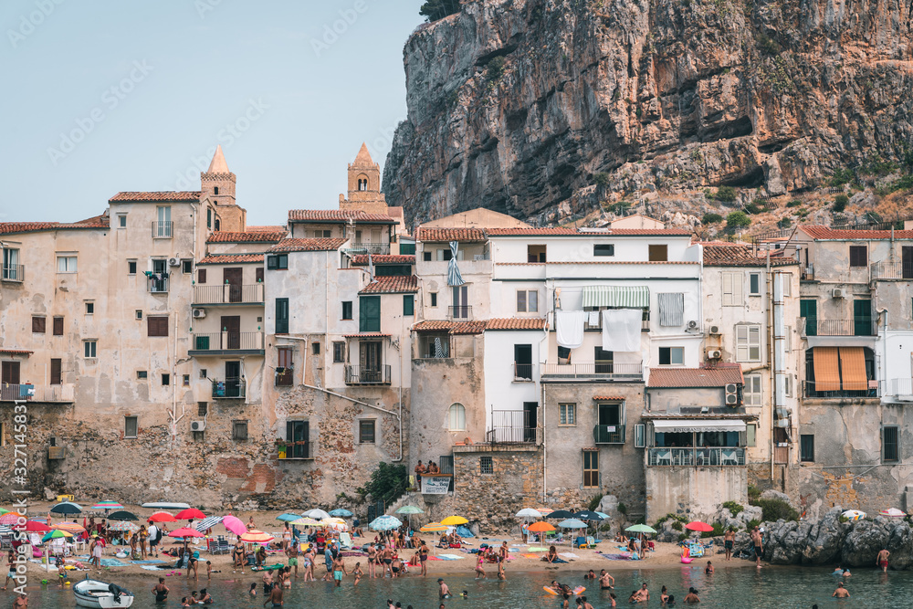 Cefalù, Sicily, Italy - August 22, 2019. Tourists visiting Cefalù, an old fishing village in Sicily