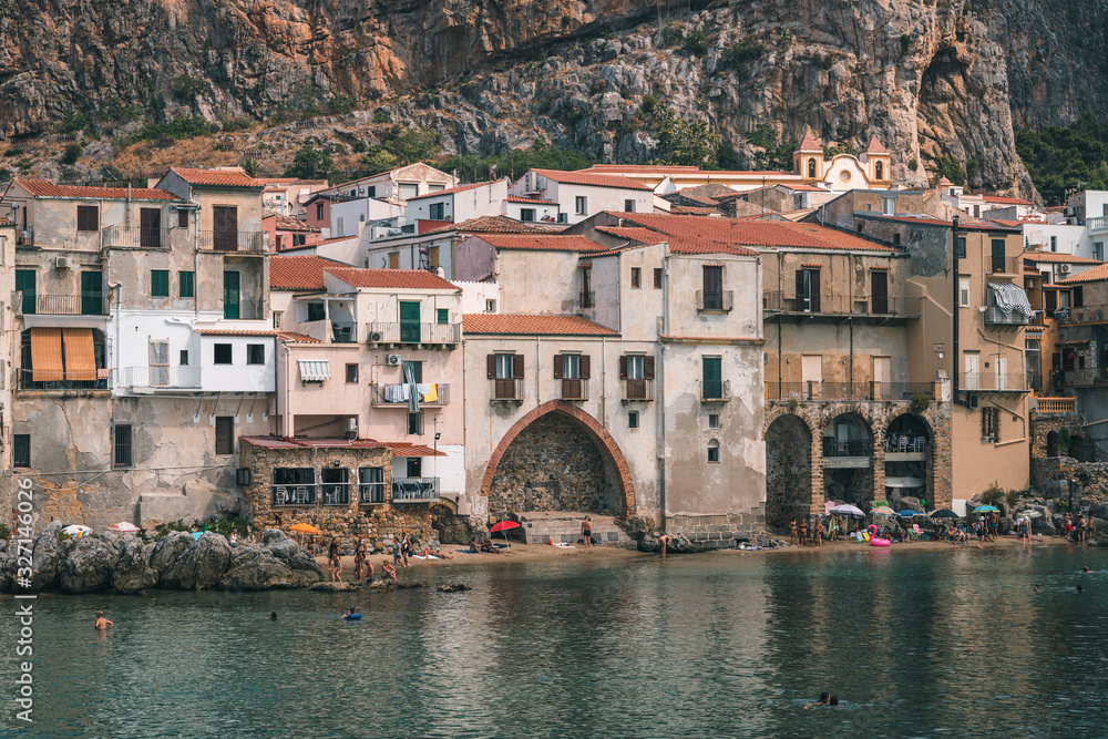 Cefalù, Sicily, Italy - August 22, 2019. The old buildings on the sea of Cefalù, an old fishing Sicilian village