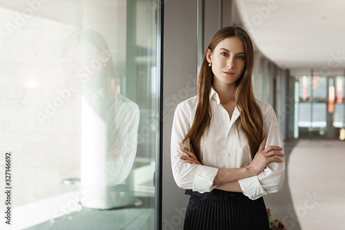 Free Download Attractive successful and strong female entrepreneur expressing confidence and power, cross hands over chest, looking camera, famous speaker prepare give lecture about woman in business - GFXLoad