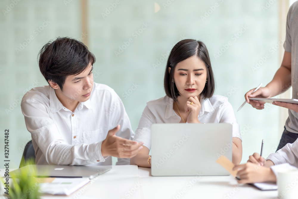Group of young asian business people together share opinions and propose new marketing and business ideas at meeting.