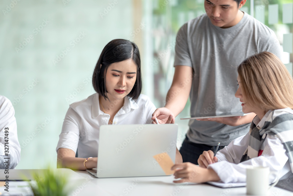 Group of young asian business people together share opinions and propose new marketing and business ideas at meeting. Group of young asian business people together share opinions and propose new marketing and business ideas at meeting.