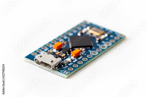 Simple small tiny microcontroller blue board macro extreme closeup, micro usb connection input hid human interface device programming electronics isolated on white, micro controller security concept