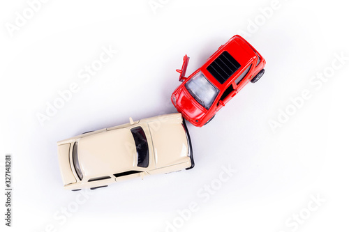 Two mini toy car crash, incident, car traffic accident, frontal collision top view, vehicle insurance abstract concept, damaged broken cars, cracked front light one door open, closeup, nobody