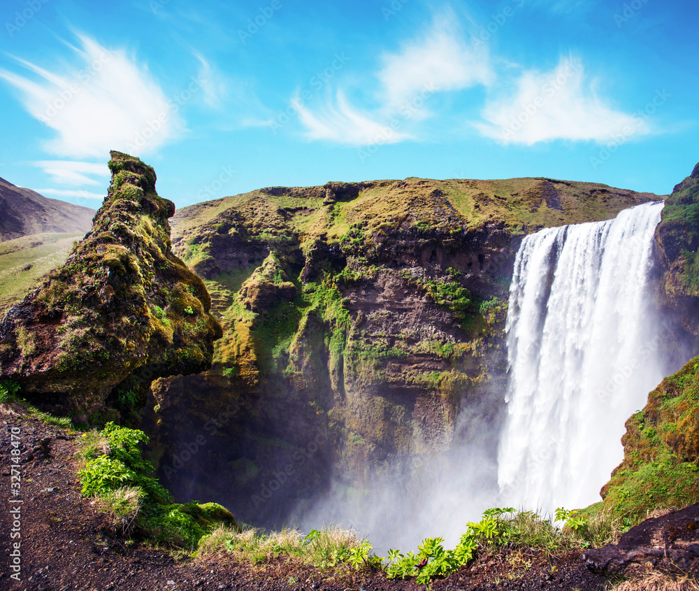 Magical landscape with silhouette of human head in front of waterfall Skogafoss in Iceland. Exotic countries. Amazing places. Popular tourist atraction.