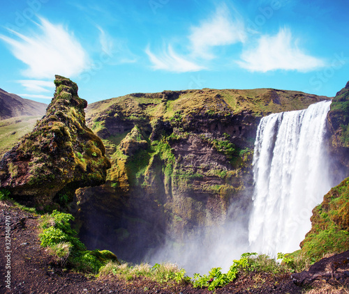 Obraz na płótnie Magical landscape with silhouette of human head in front of waterfall Skogafoss in Iceland. Exotic countries. Amazing places. Popular tourist atraction. w salonie