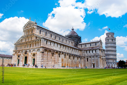 Obraz na płótnie Picturesque landscape with San Giovanni Baptistery, part of cathedral or Duomo di Santa Maria Assunta near famous Leaning Tower in Pisa, Italy. fascinating exotic amazing places. Piazza dei Miracoli. w salonie