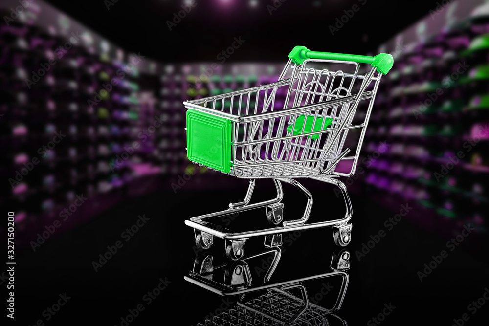 Cart on wheels isolated on the background of rows of goods.