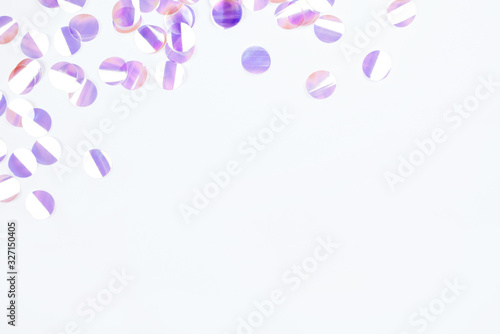 Pearl confetti on white background. Flat lay, top view. © Anna
