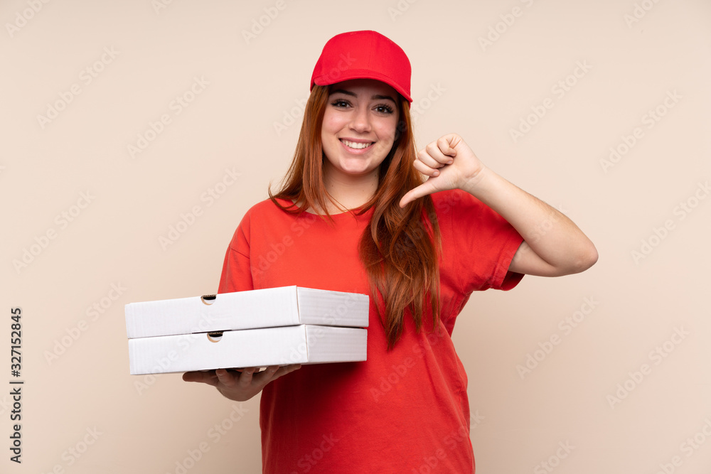 Pizza delivery teenager girl holding a pizza over isolated background proud and self-satisfied Pizza delivery teenager girl holding a pizza over isolated background proud and self-satisfied