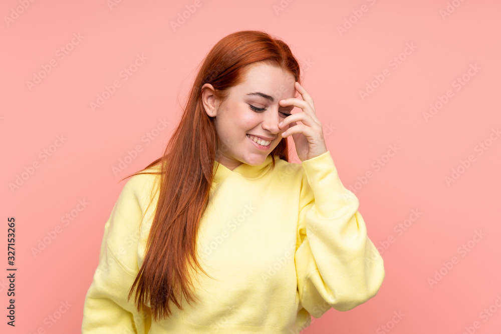 Redhead teenager girl over isolated pink background laughing Redhead teenager girl over isolated pink background laughing
