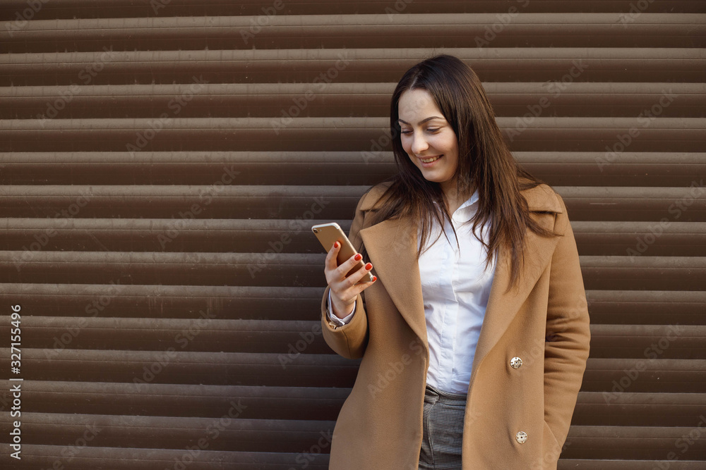 Happy beautiful girl using smart phone in the city Happy beautiful girl using smart phone in the city