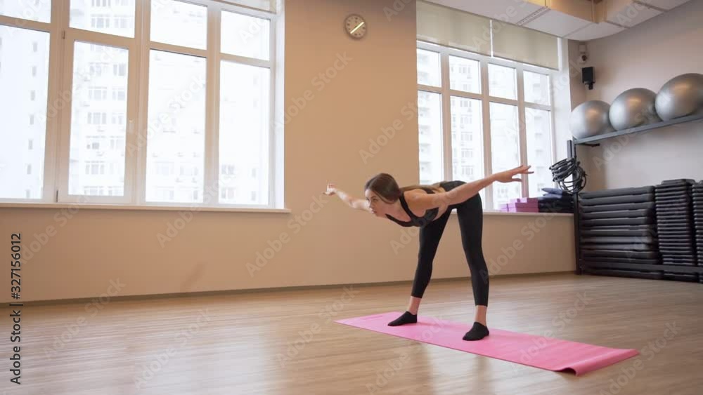 4x slow motion video of Beautiful young woman working out and stretching indoors 4x slow motion video of Beautiful young woman working out and stretching indoors