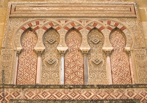 Arcos arabes en la puerta de San Ildefonso de la Mezquita de Córdoba photo