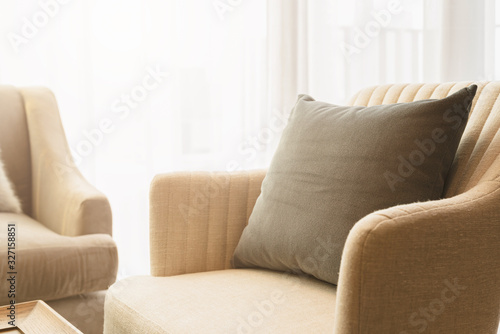 soft cozy beige color pillows on modern sofa with wallpaper wall cover background home design concept