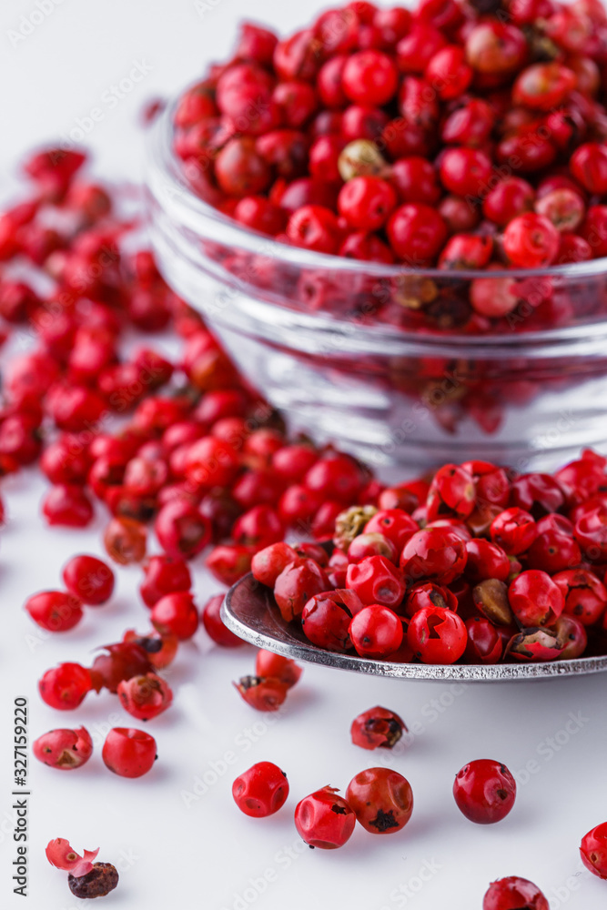 fragrant pink peppercorns on white acrylic background fragrant pink peppercorns on white acrylic background