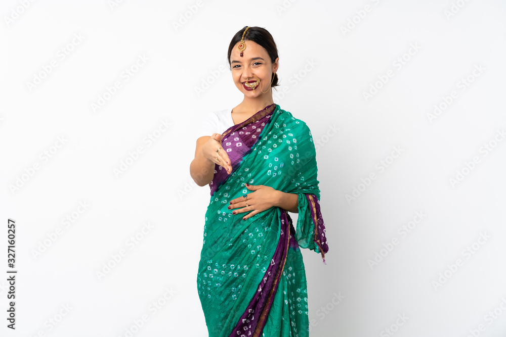 Young indian woman isolated on white background shaking hands for closing a good deal