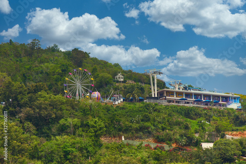 Carnival with rides on a tropical hilltop