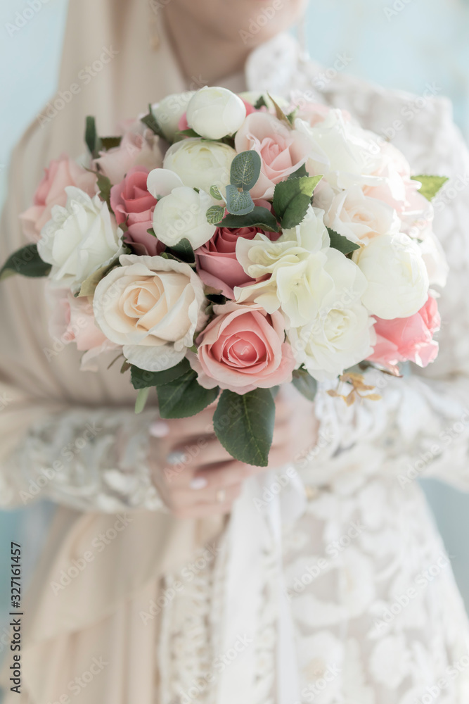 delicate wedding bouquet in the hands of the bride close-up