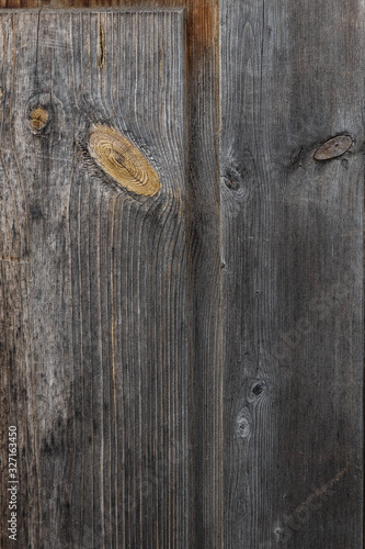 Old wood texture. Board of old natural wood with knots cracks and scuffs. Grey brown wooden vintage background.
