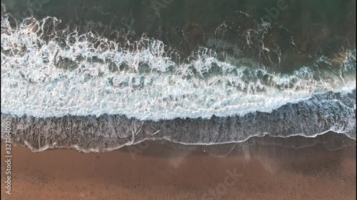 Looped seamless background from Sea tide with waves Green and orange colors with white foam