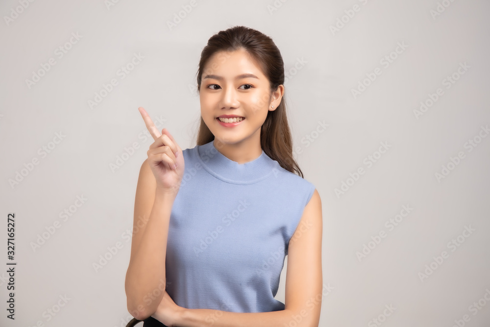 Thinking asian woman stand up isolated on white background.Asian female model smiling looking up.woman pointing fingers away on white background isolated. Thinking asian woman stand up isolated on white background.Asian female model smiling looking up.woman pointing fingers away on white background isolated.