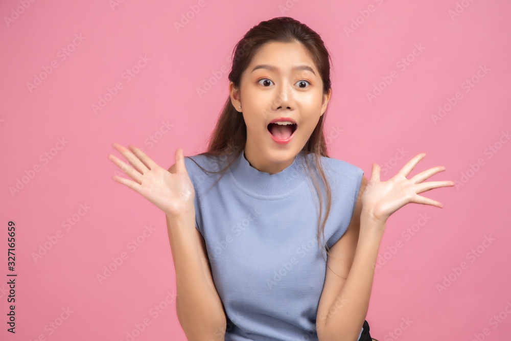 Thinking asian woman stand up isolated on white background.Asian female model smiling looking up.woman pointing fingers away on white background isolated. Thinking asian woman stand up isolated on white background.Asian female model smiling looking up.woman pointing fingers away on white background isolated.