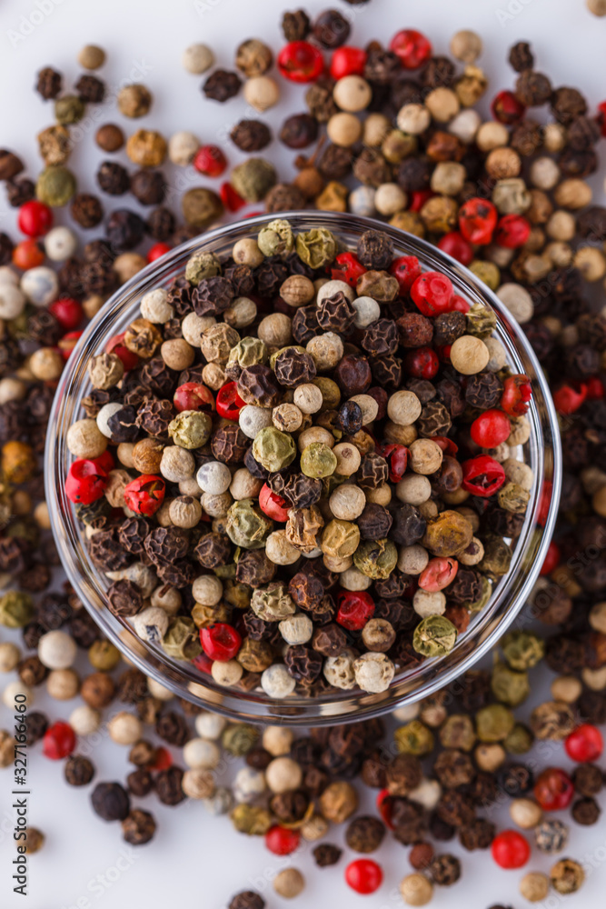 mix of peppercorns on white acrylic background mix of peppercorns on white acrylic background