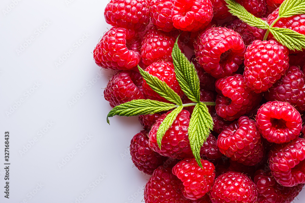 Juicy fresh natural raspberries on white acrylic background Juicy fresh natural raspberries on white acrylic background